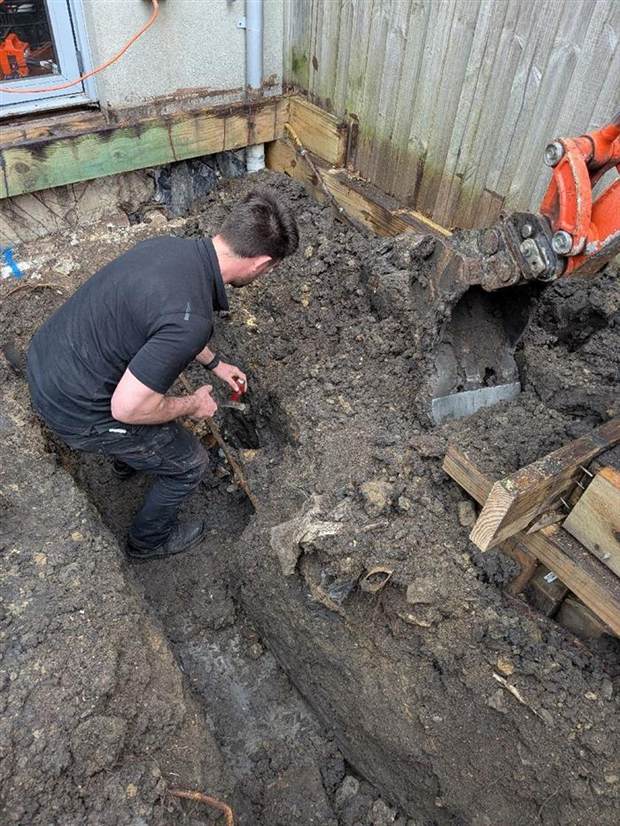 A Zebra plumber working at the base of the shored trench during the Fitzroy North sewer renewal