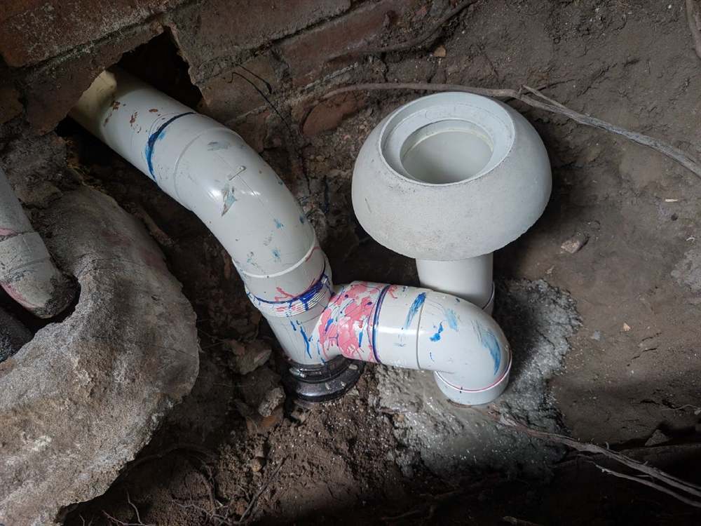 New sewer-grade PVC pipe and overflow relief point installed at the South Yarra apartment block