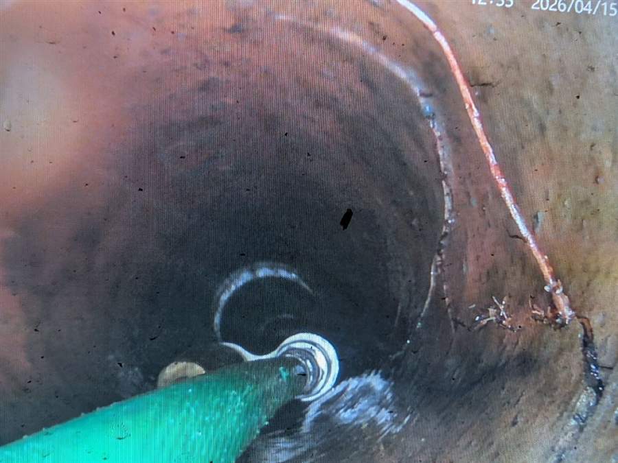 Drain camera view of a crack running through a clay sewer pipe