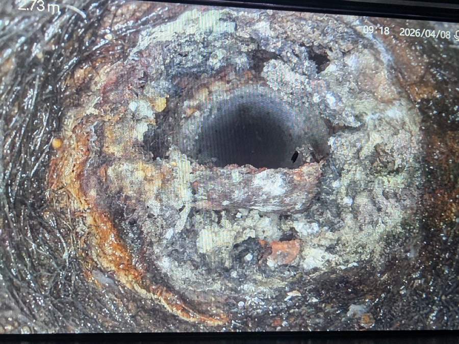 Drain camera view of heavy internal corrosion closing down an old cast iron sewer