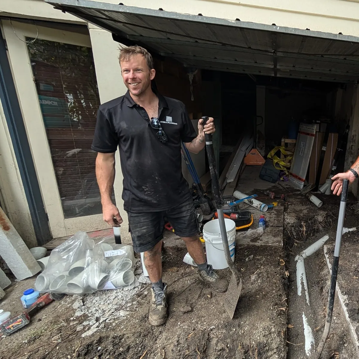 Taylor from Zebra Plumbing beside a freshly laid drain line on a Melbourne renewal job