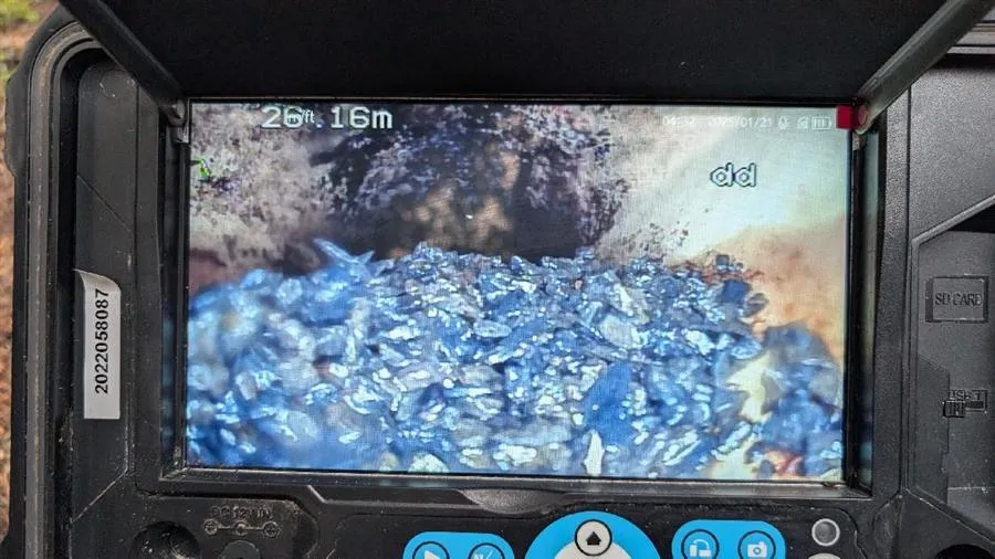CCTV drain camera showing rocks and gravel filling a stormwater line 26 metres down